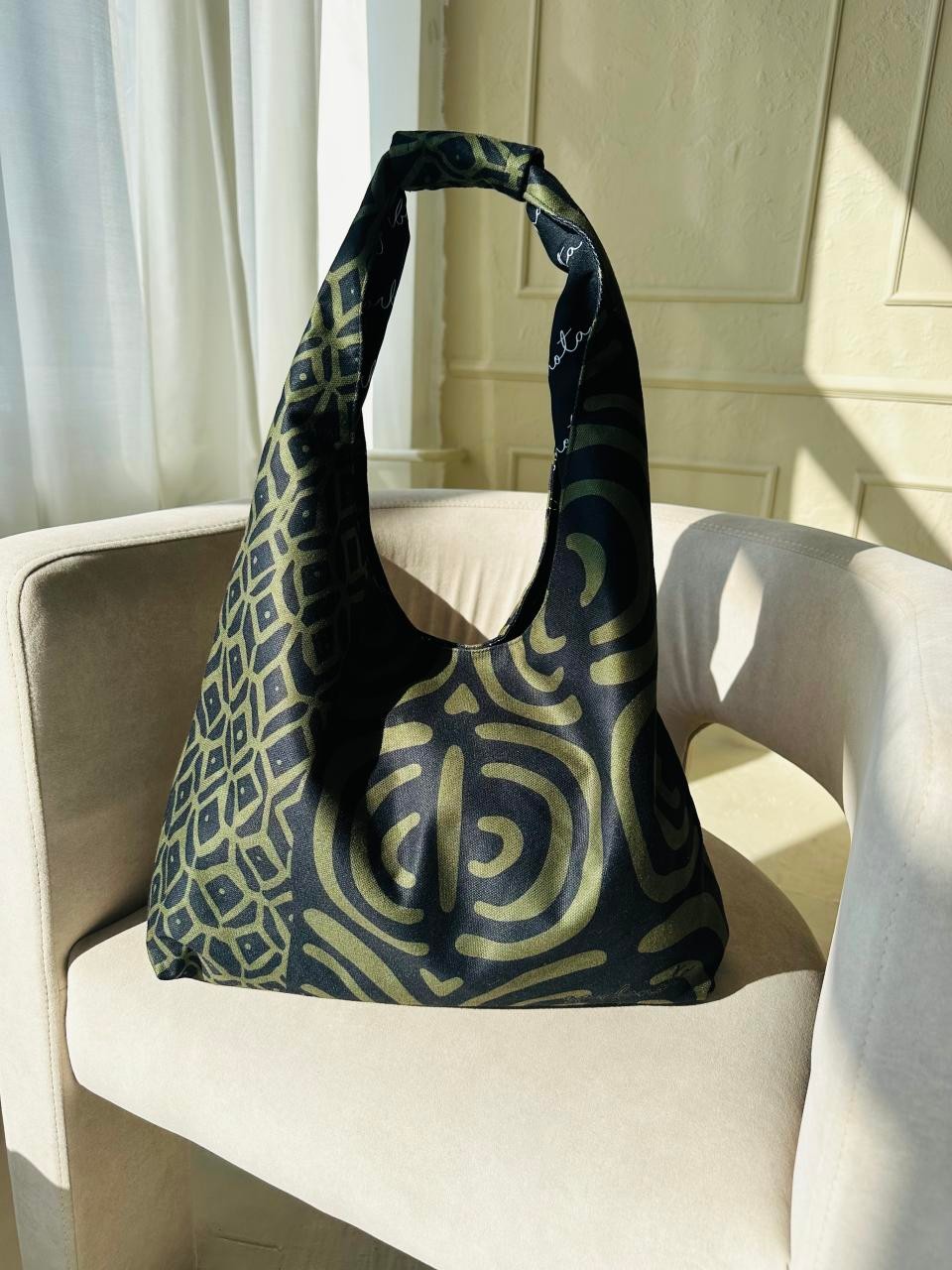 soft khaki moon bag with its unique garbanota pattern lining shown in comforting morning light