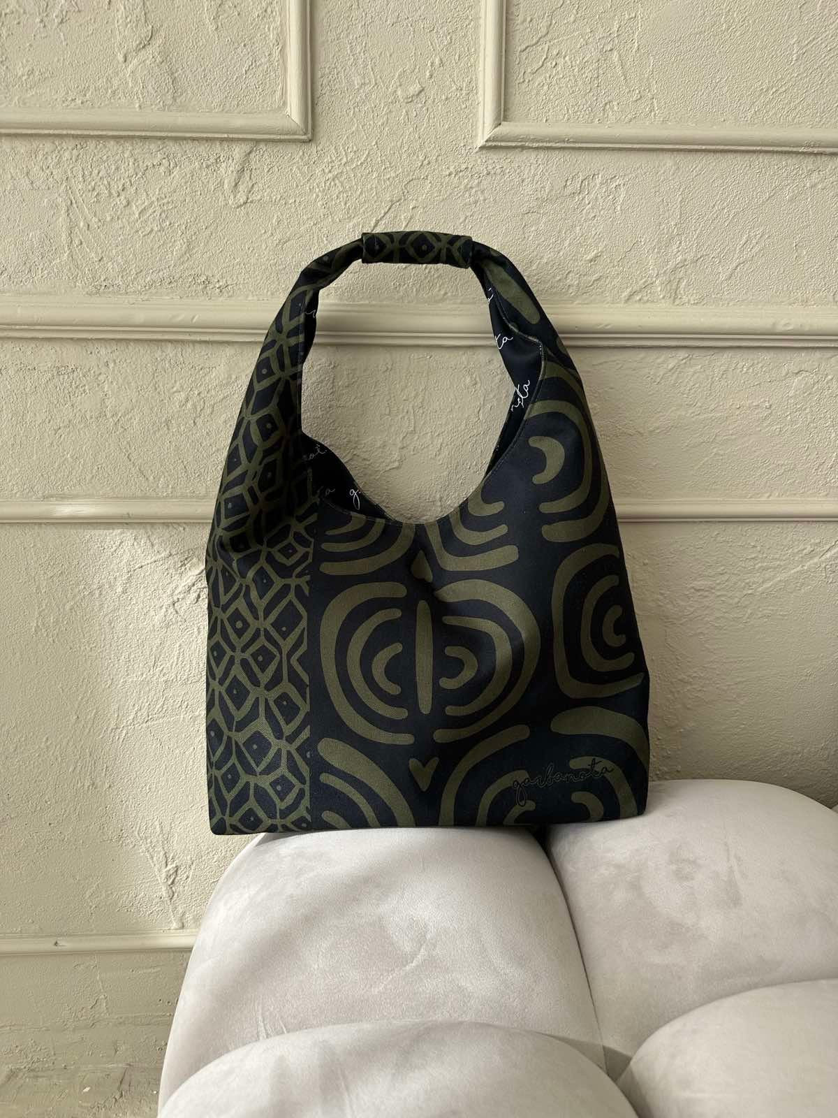 elegant khaki moon bag with unique garbanota lining, shown in a refined setting