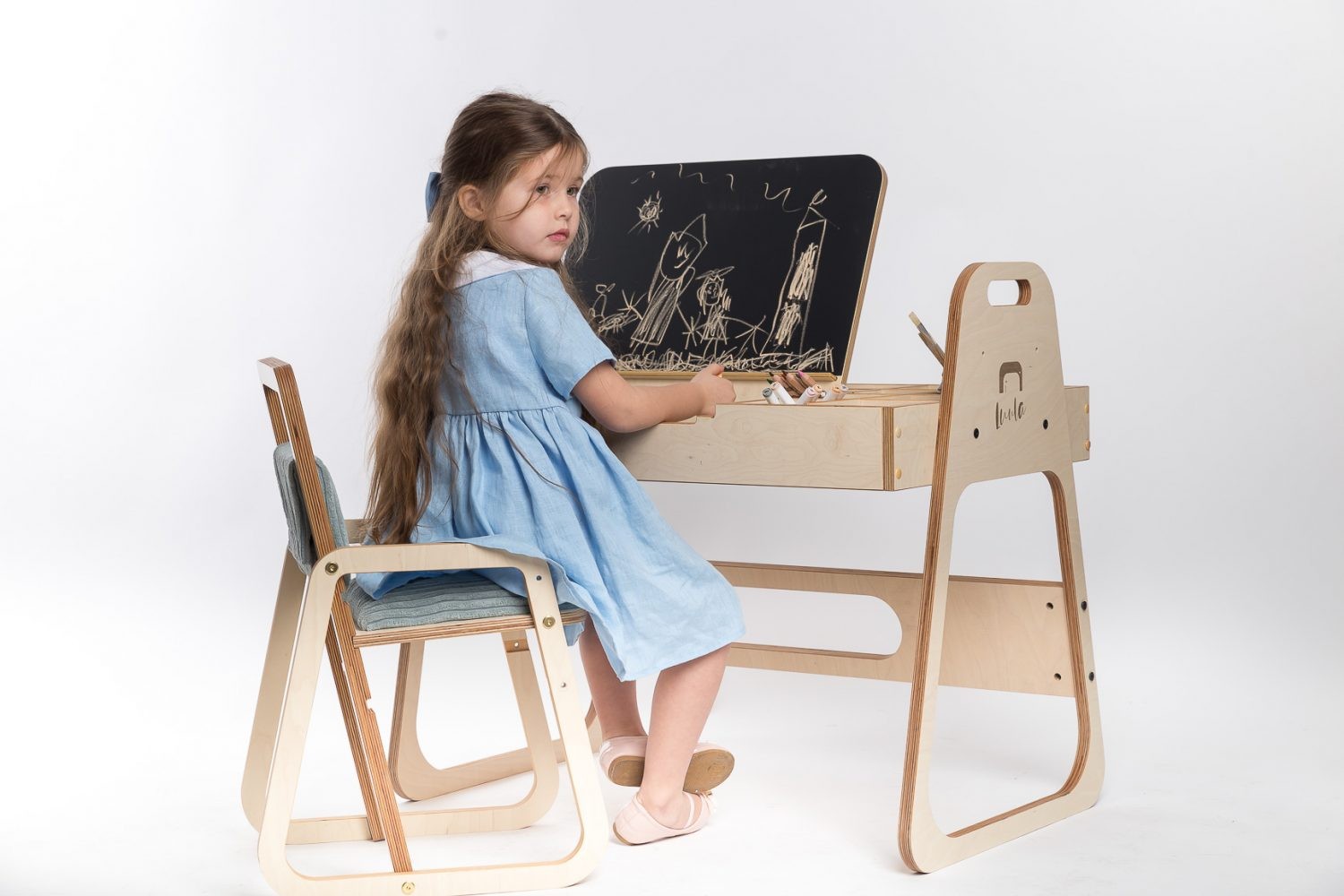 bold modern julle kids art table with chalkboard and paper roll in a bright playroom