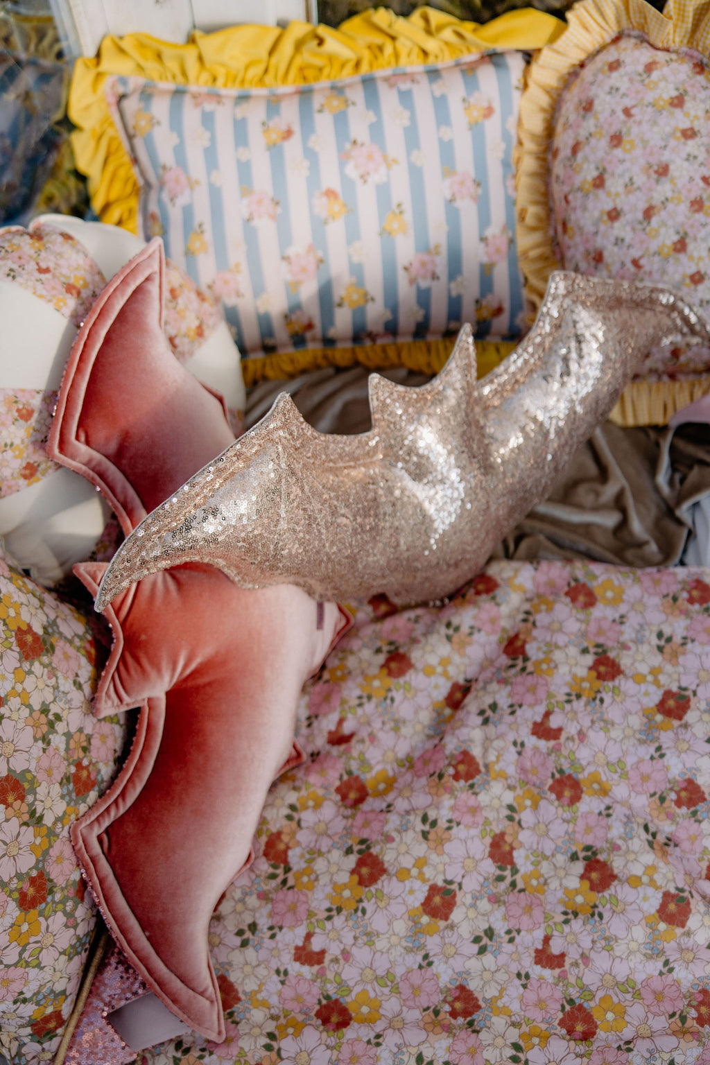 close-up of a playful spring garden muslin baby blanket with a tiny pillow on a sunny windowsill