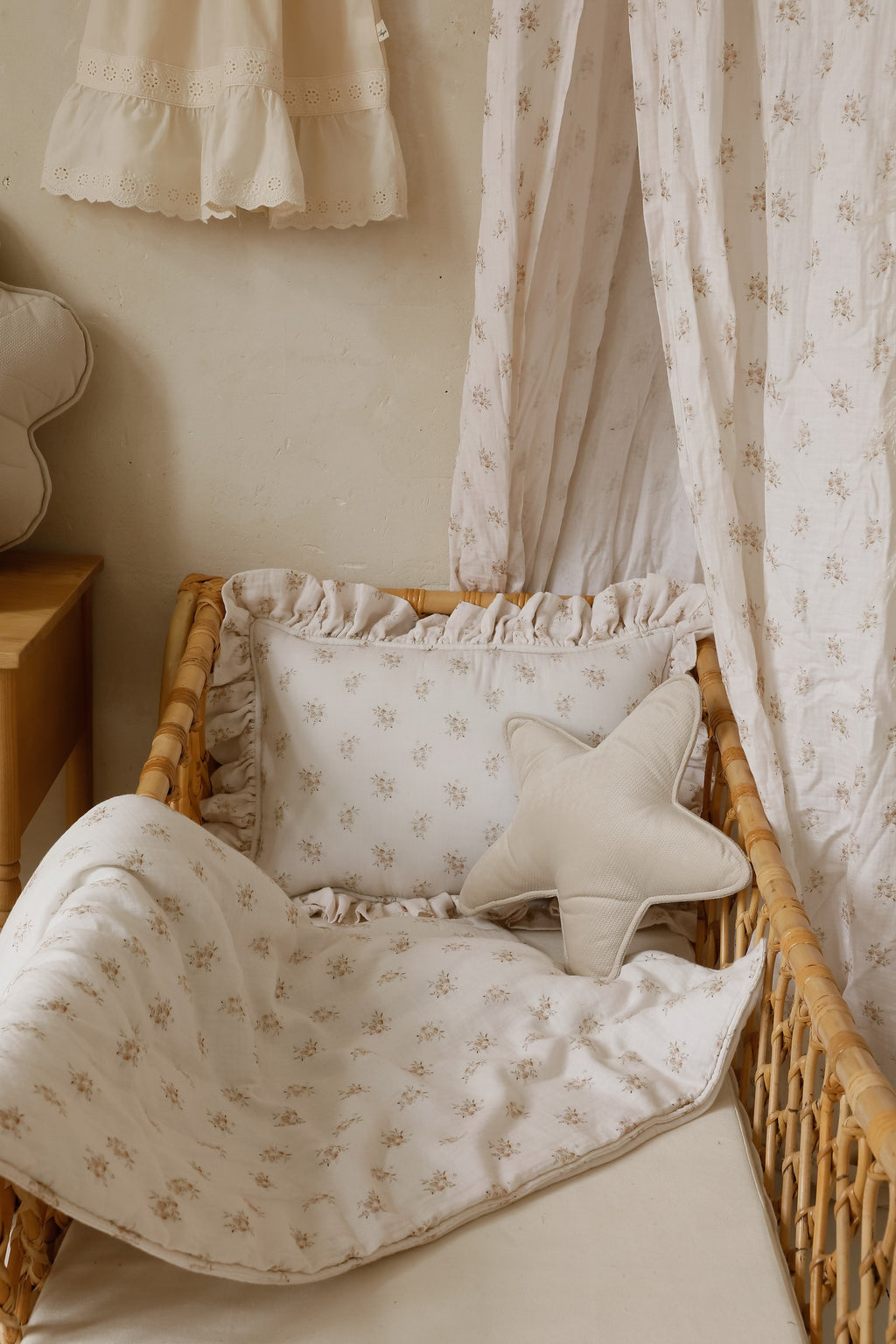 boho flower muslin baby blanket and pillow set - soft cotton for peaceful naps, draped over a rustic wooden crib