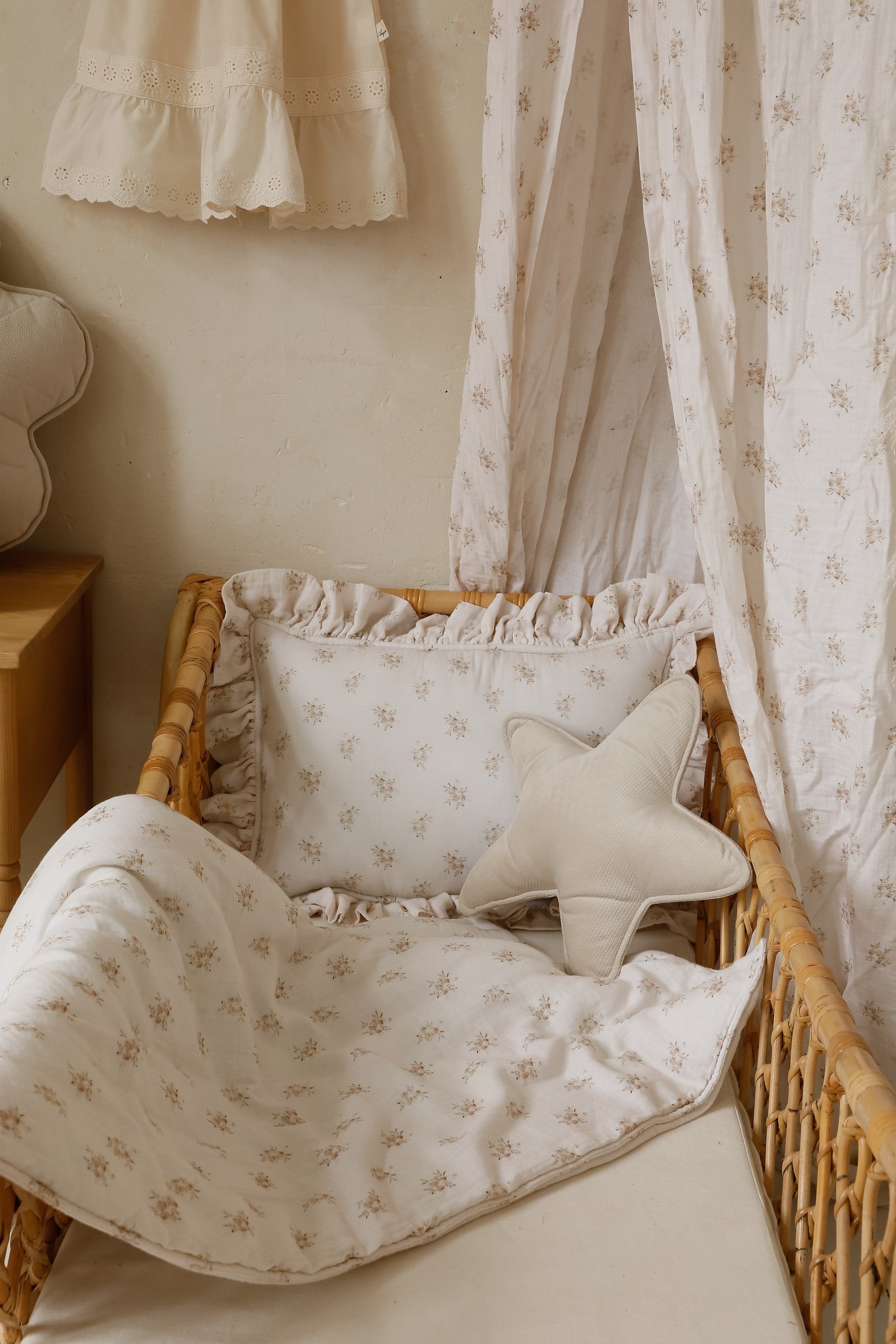 boho flower muslin baby blanket and pillow set - soft cotton for peaceful naps, draped over a rustic wooden crib