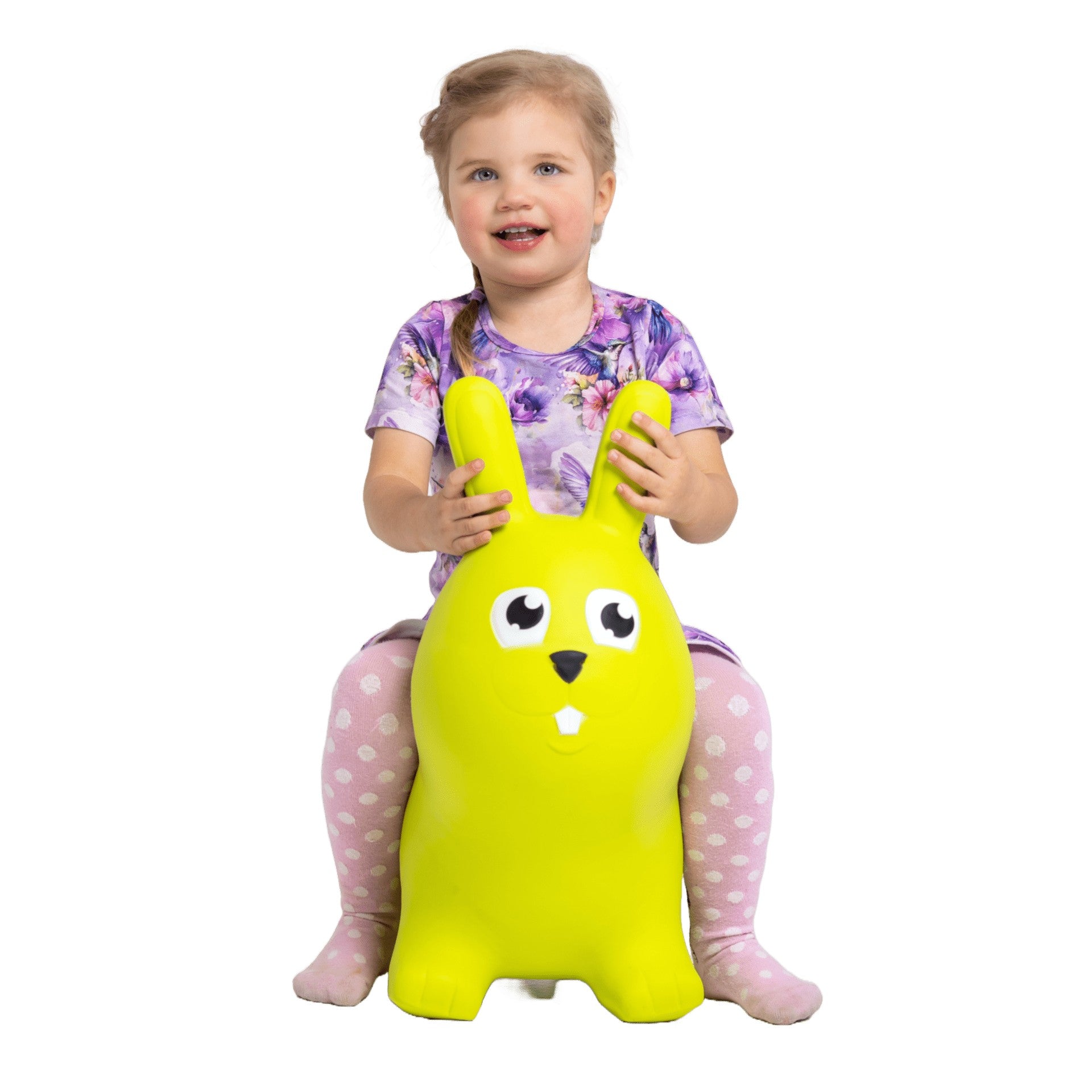 confident toddler on a vibrant green bunny hopper toy indoors
