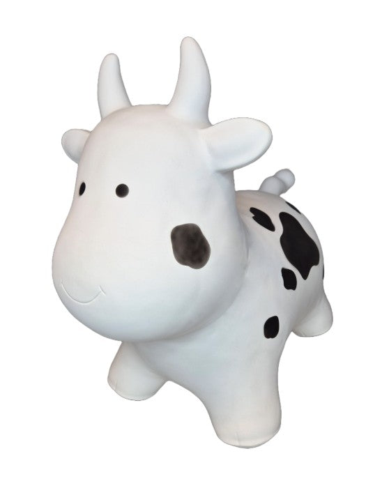 soft white cow hopper toy for toddlers in a cozy nursery setting