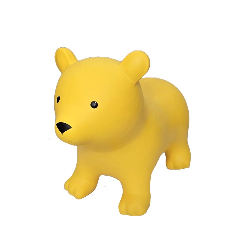 a soft yellow bear jumpy toy resting gently on a cozy nursery rug