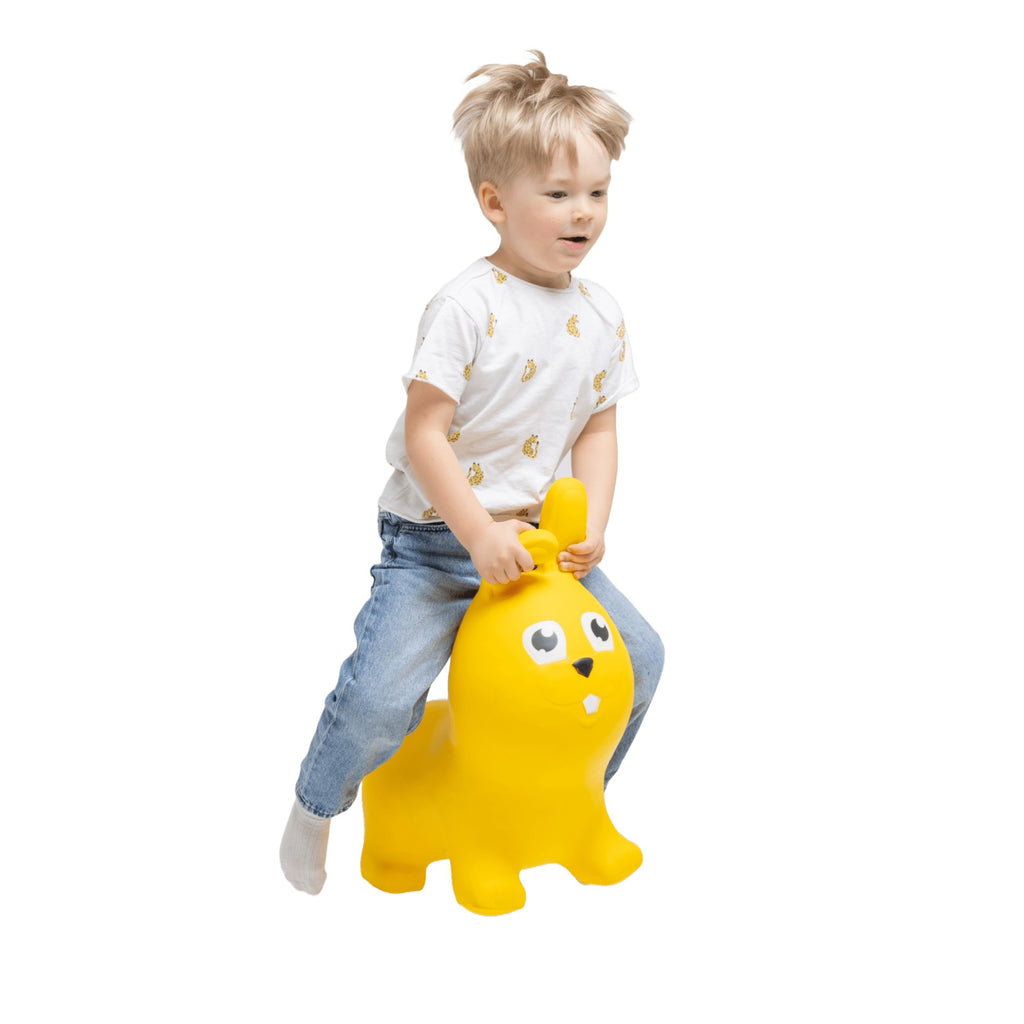 bold yellow bunny hopper toy for kids on a bright playroom floor