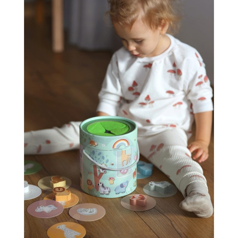 bold close-up of a child's hand reaching into the touch and match mystery box for a tactile challenge