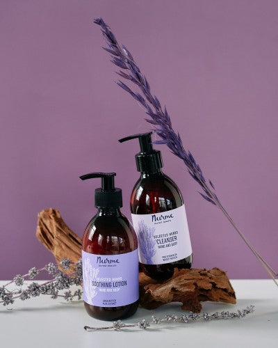 bold shot of artisan lavender gift set with pump bottles against a dark slate background