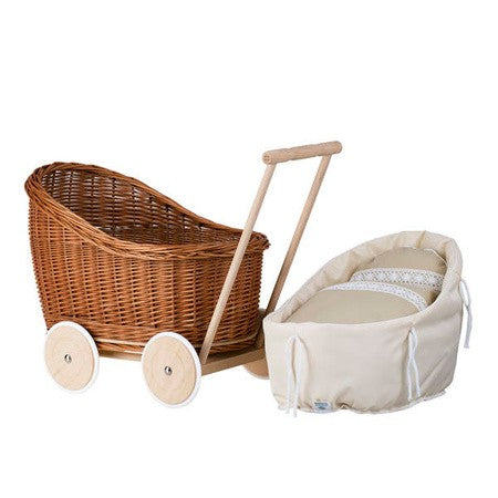 elegant natural wicker doll pram luna with soft beige bedding in a refined nursery setting
