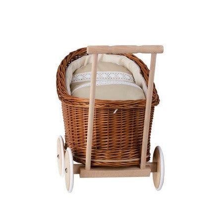 close-up of the handmade wicker pram's cozy beige bedding and pillow