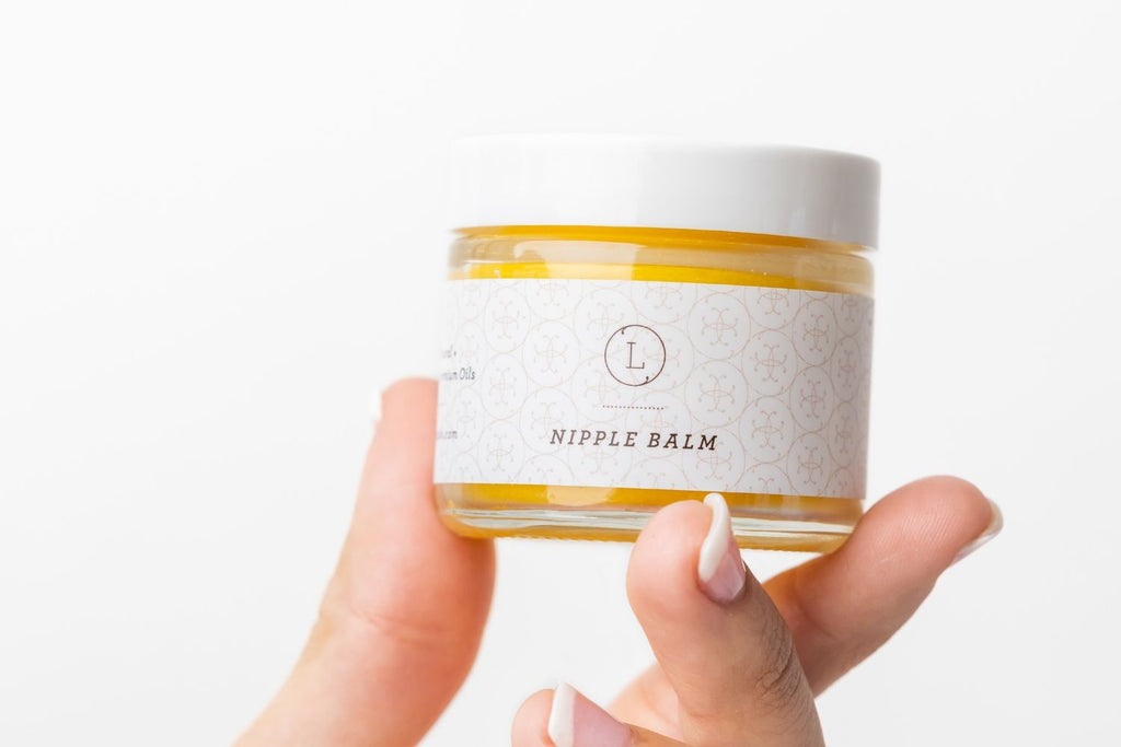confident close-up of organic nipple balm jar with golden beeswax texture