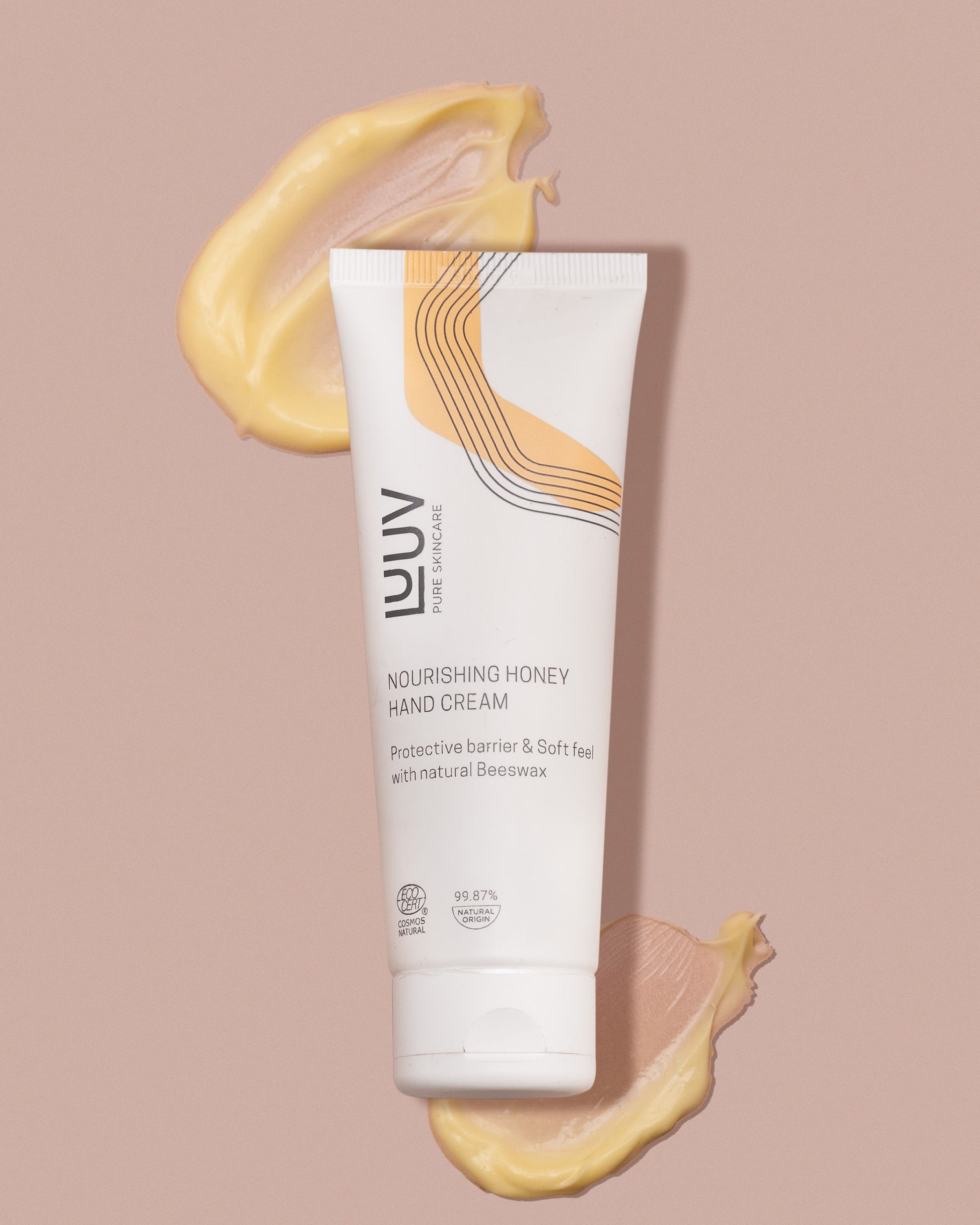 a soft-focus close-up of nourishing honey hand cream being gently smoothed onto skin