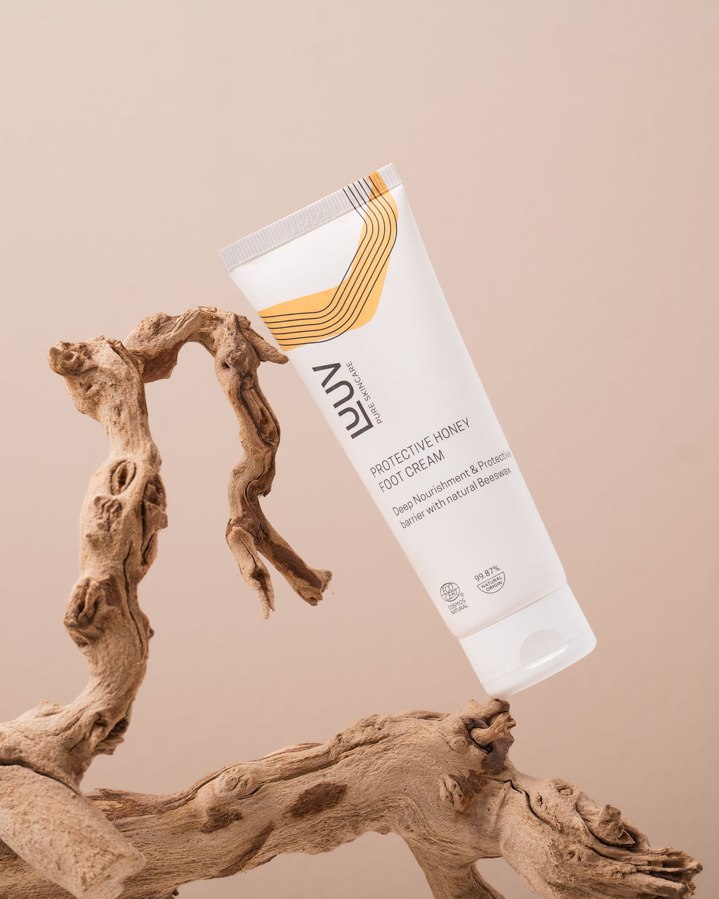 a playful squirt of luuv honey foot cream with a golden honey swirl