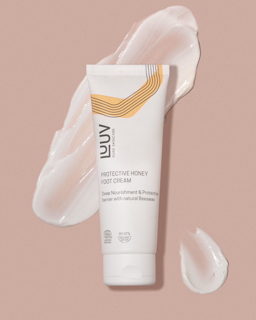 a soft-focused close-up of luuv honey foot cream with a gentle golden glow