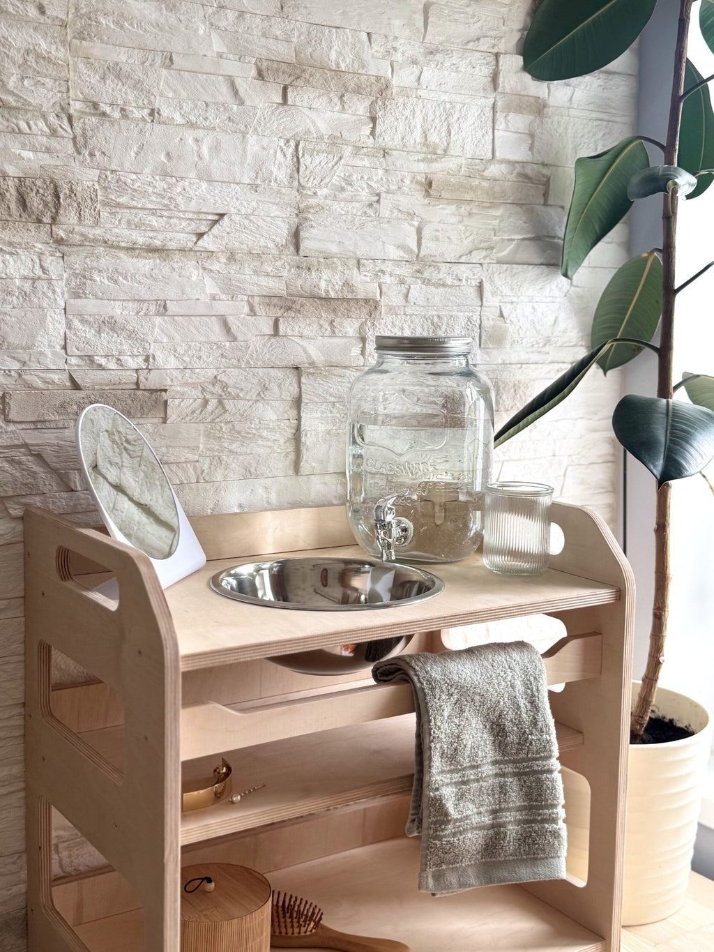 a bold, low-angle shot of the montessori wooden washbasin showcasing its empowering child-height design