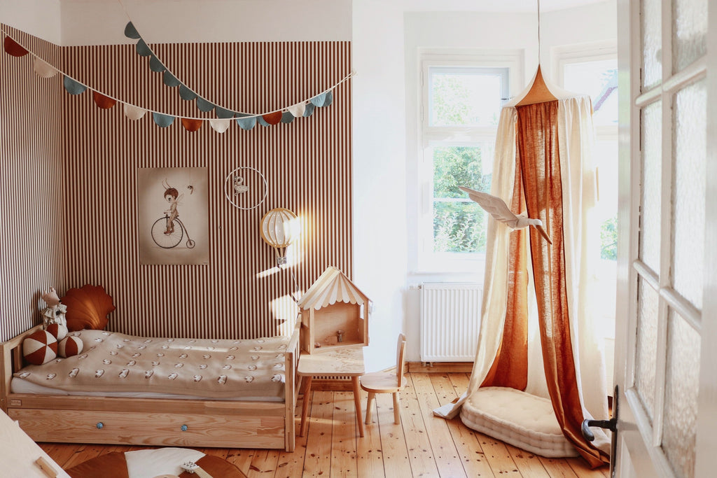 organic cotton and linen canopy in caramel circus color, hanging over a bed with soft fabric draping down