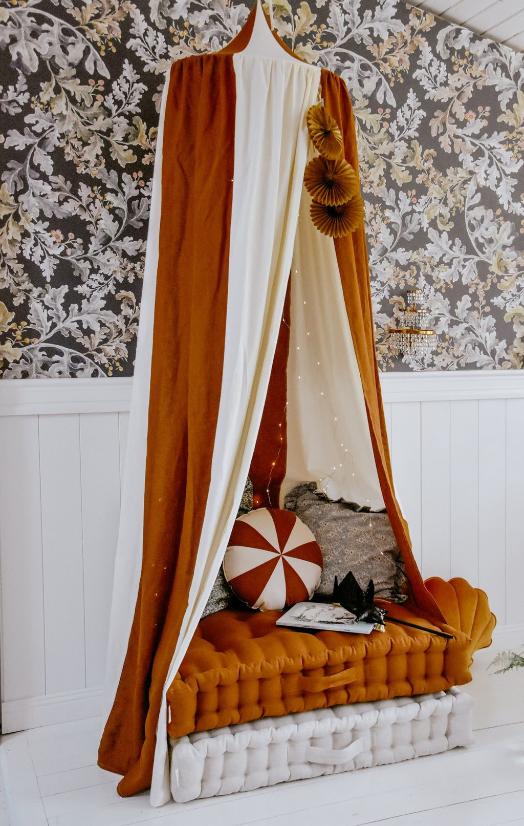 caramel circus organic cotton and linen canopy draped gracefully over a bed, soft light filtering through the fabric