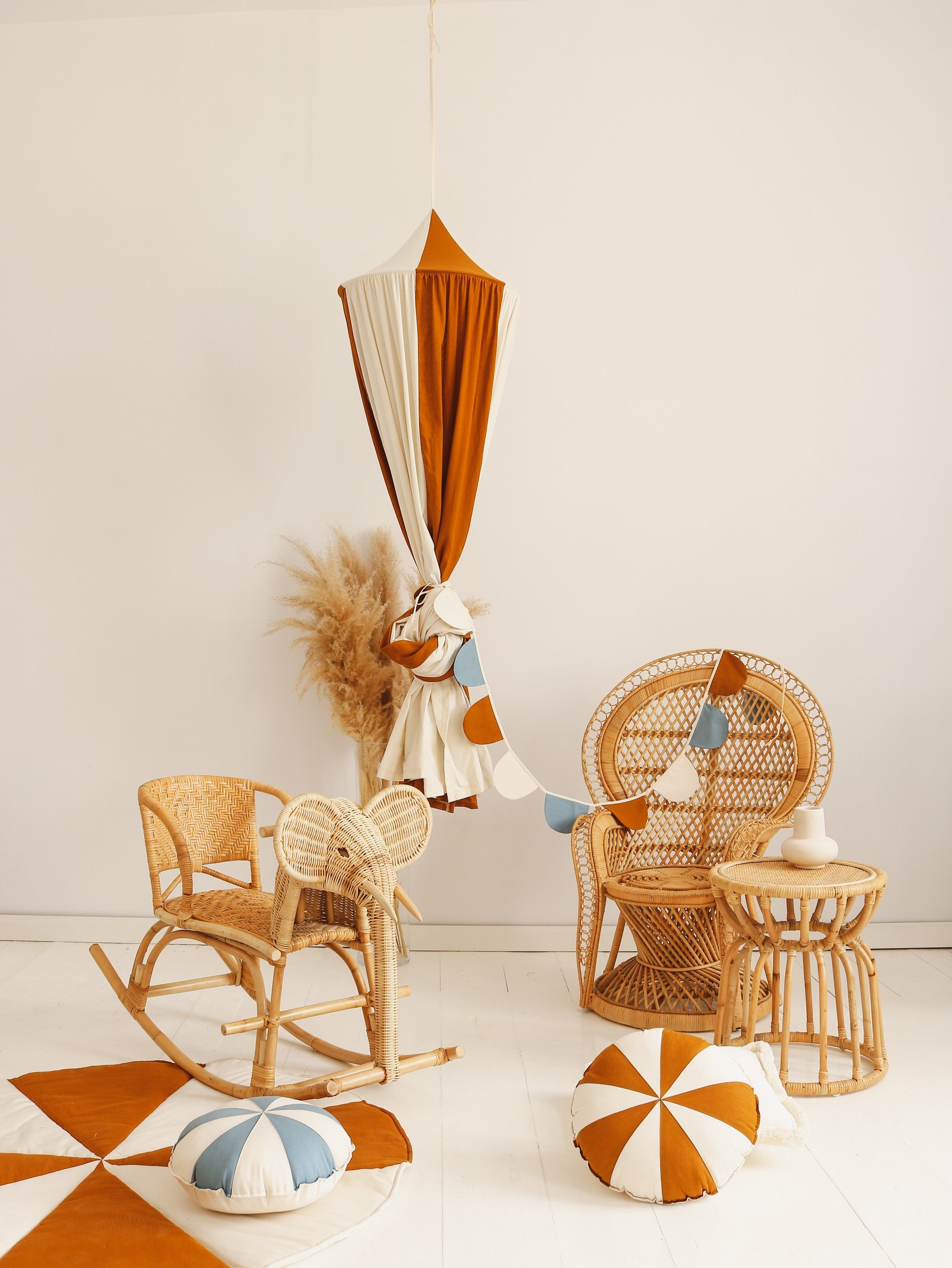 caramel circus organic cotton and linen canopy draped gracefully over a bed, soft light filtering through the fabric