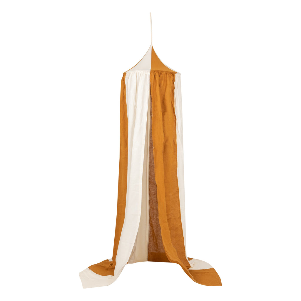 caramel circus organic cotton and linen canopy draped gracefully over a bed, soft light filtering through the fabric