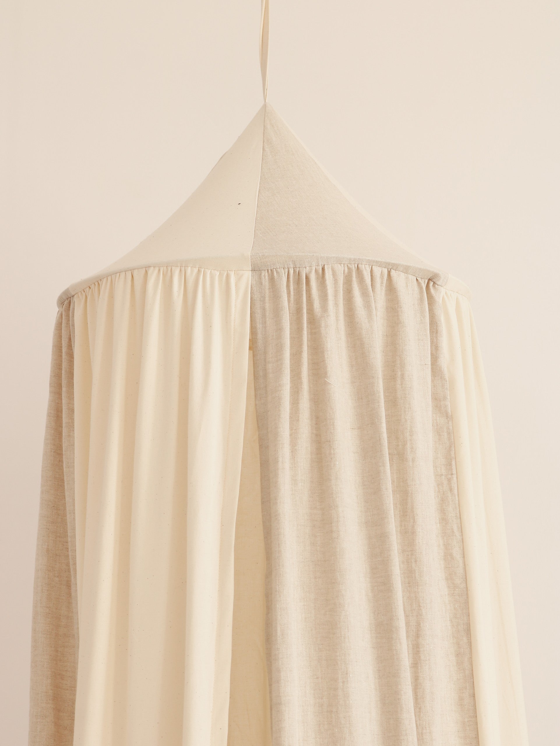 bold cream circus organic cotton and linen canopy hanging over a cozy bed with soft natural light