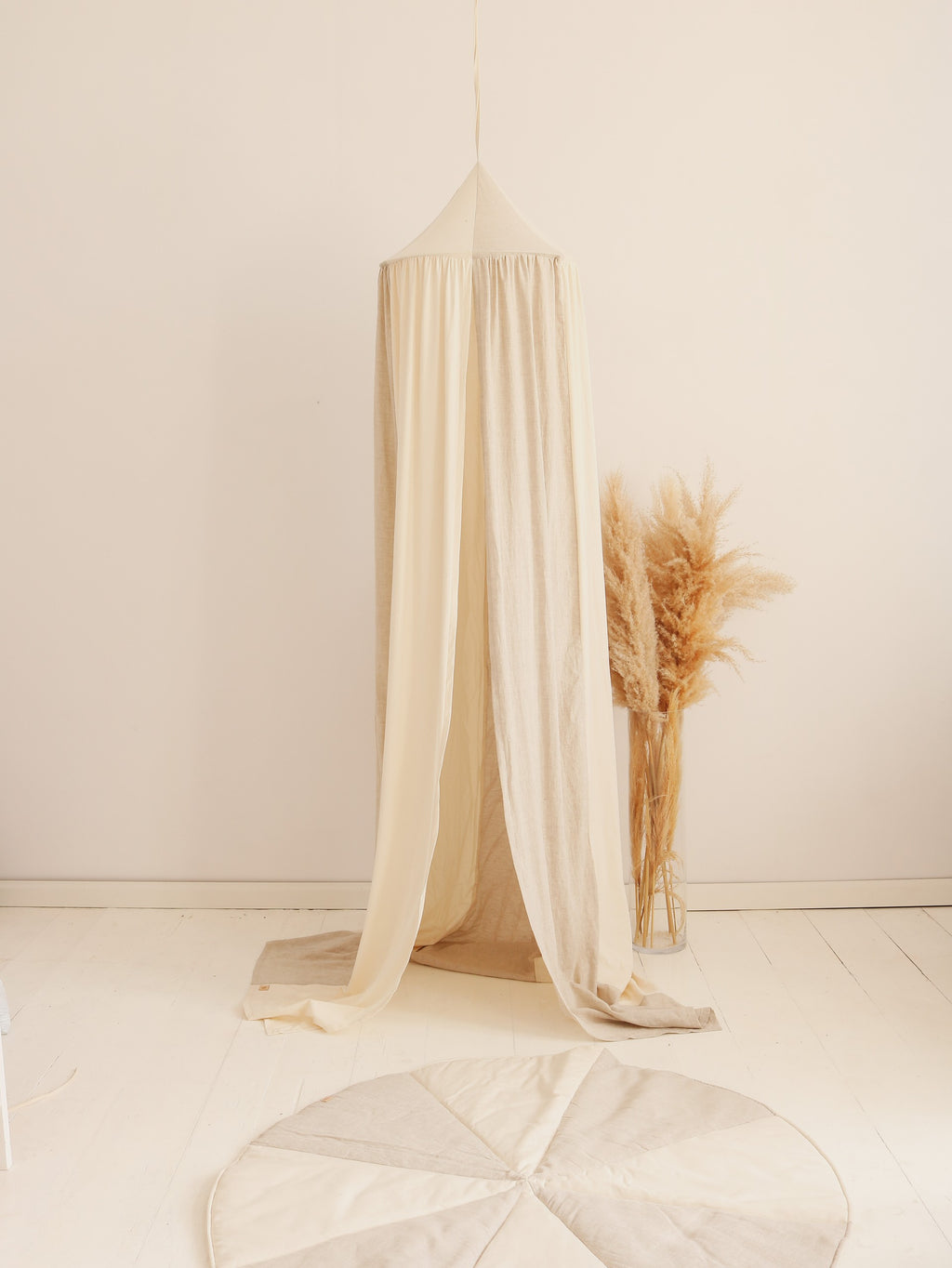 artisan-made cream and grey cotton linen canopy hanging over a child's bed with soft morning light