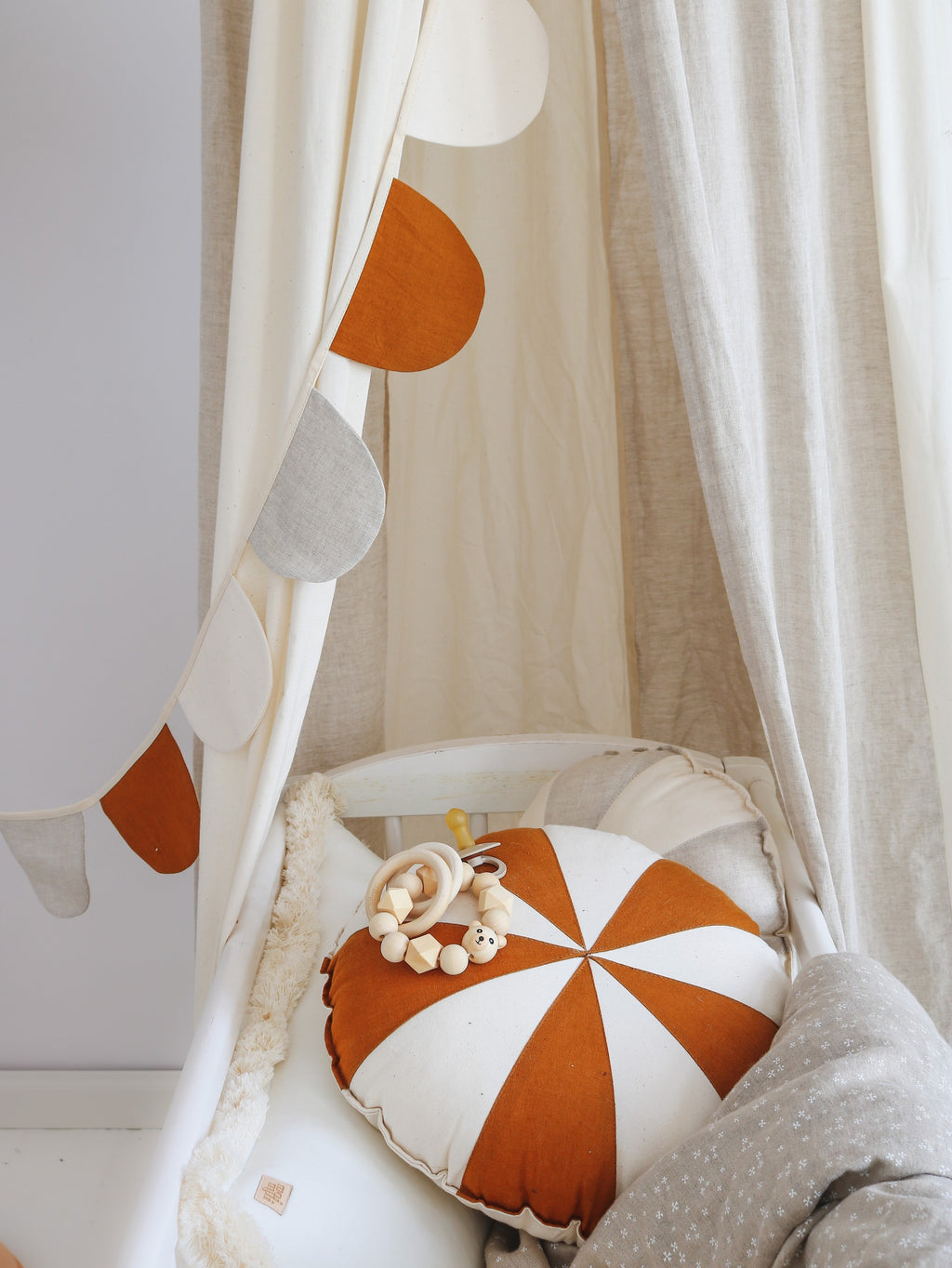 cream circus organic cotton and linen canopy draped gracefully over a bed, soft light filtering through the fabric