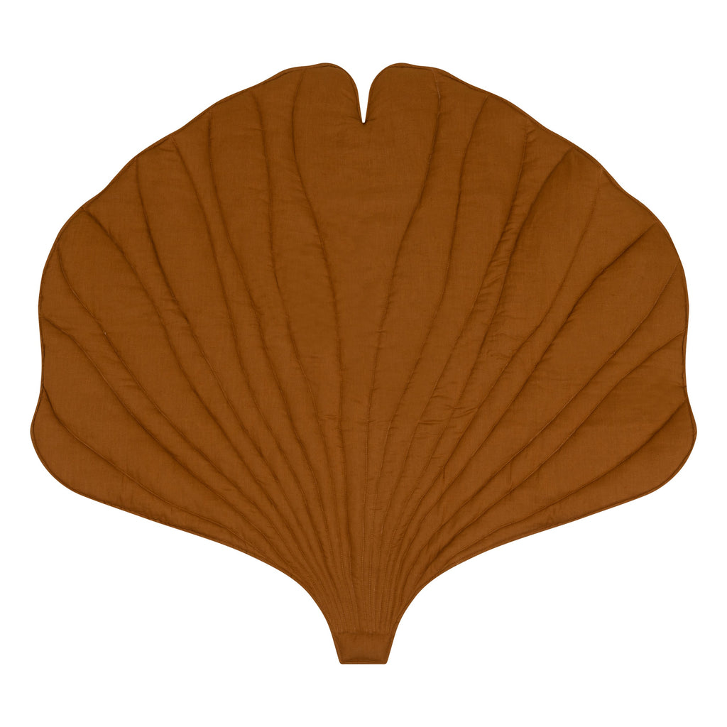 handmade caramel ginkgo leaf playmat laid flat on hardwood floor showing its practical size and plush texture