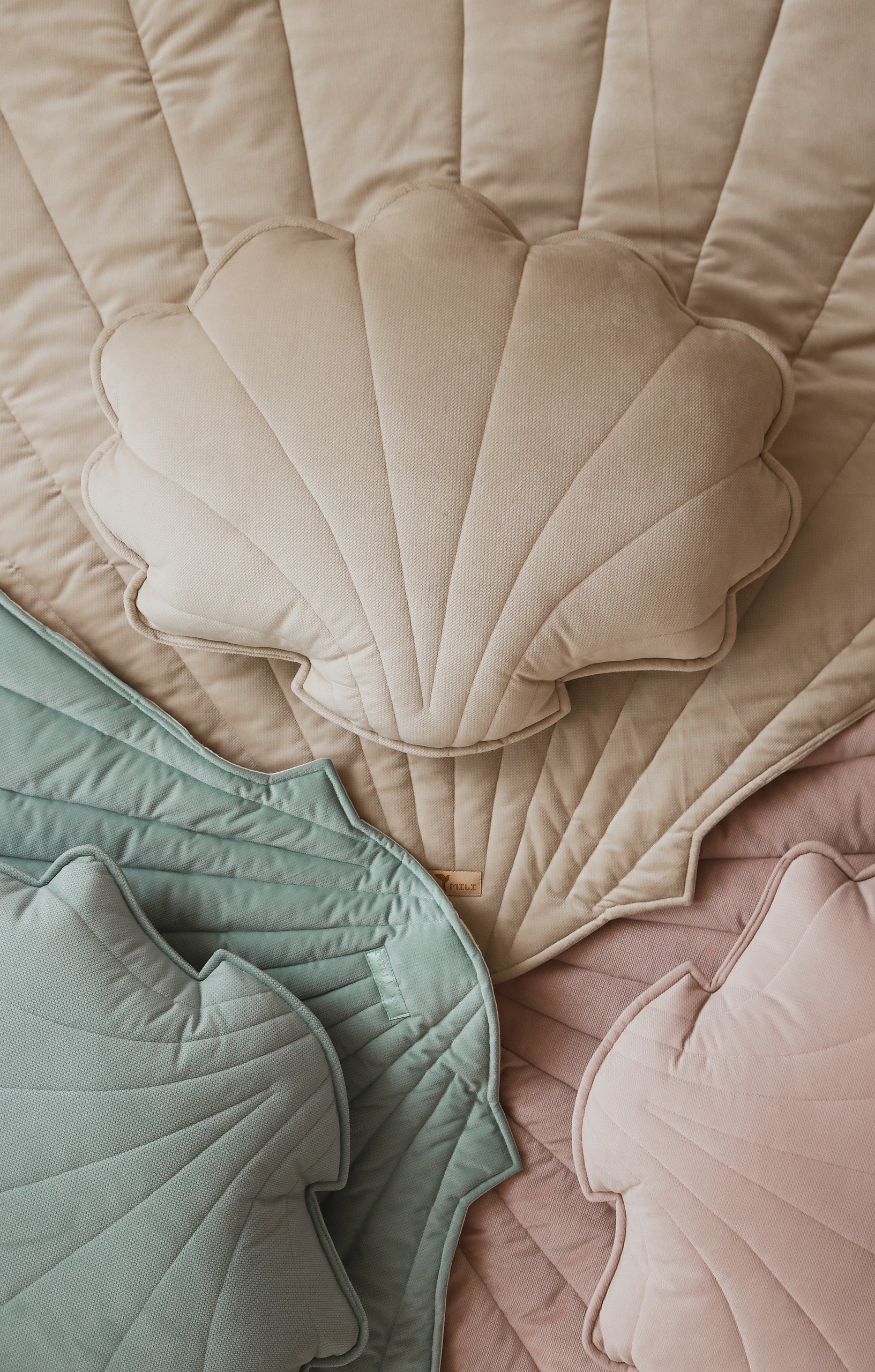 beige organic cotton and velvet ginkgo leaf playmat spread on grass under dappled sunlight