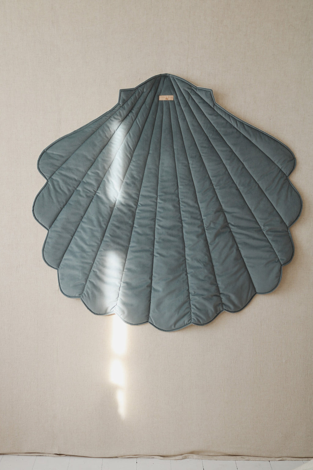 soft blue ginkgo leaf playmat on grass, perfect for cozy picnics and toddler playtime