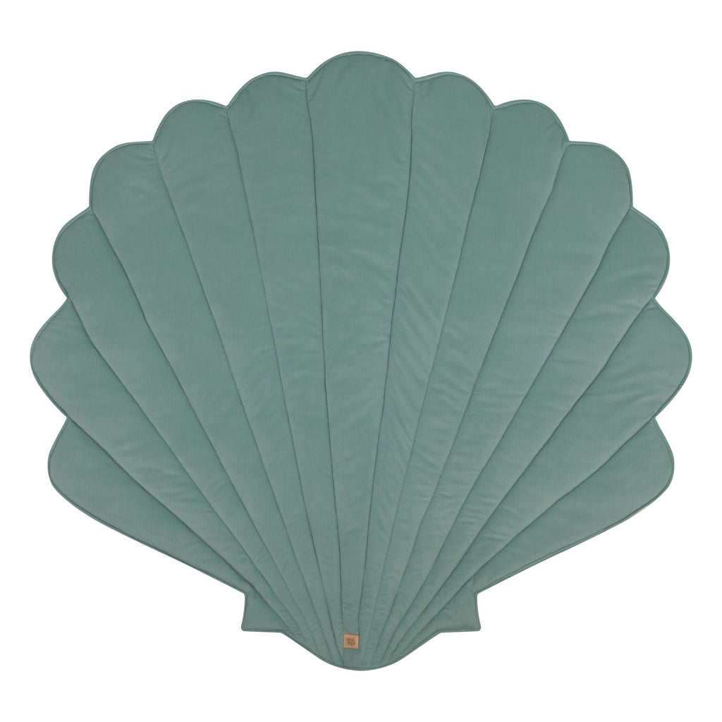 a playful mint ginkgo leaf playmat with a toddler giggling on its soft velvet surface