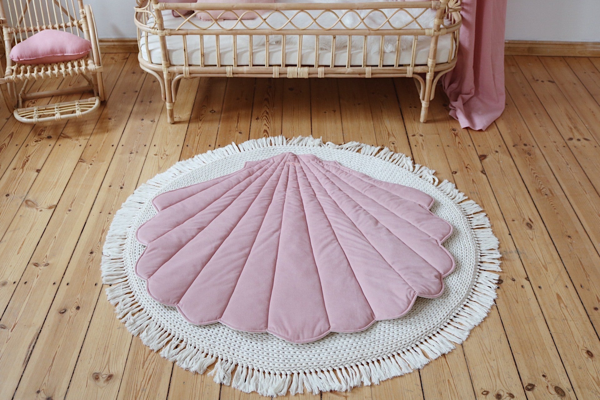 powder pink organic cotton and velvet ginkgo leaf playmat spread on grass, soft and inviting for picnics or play