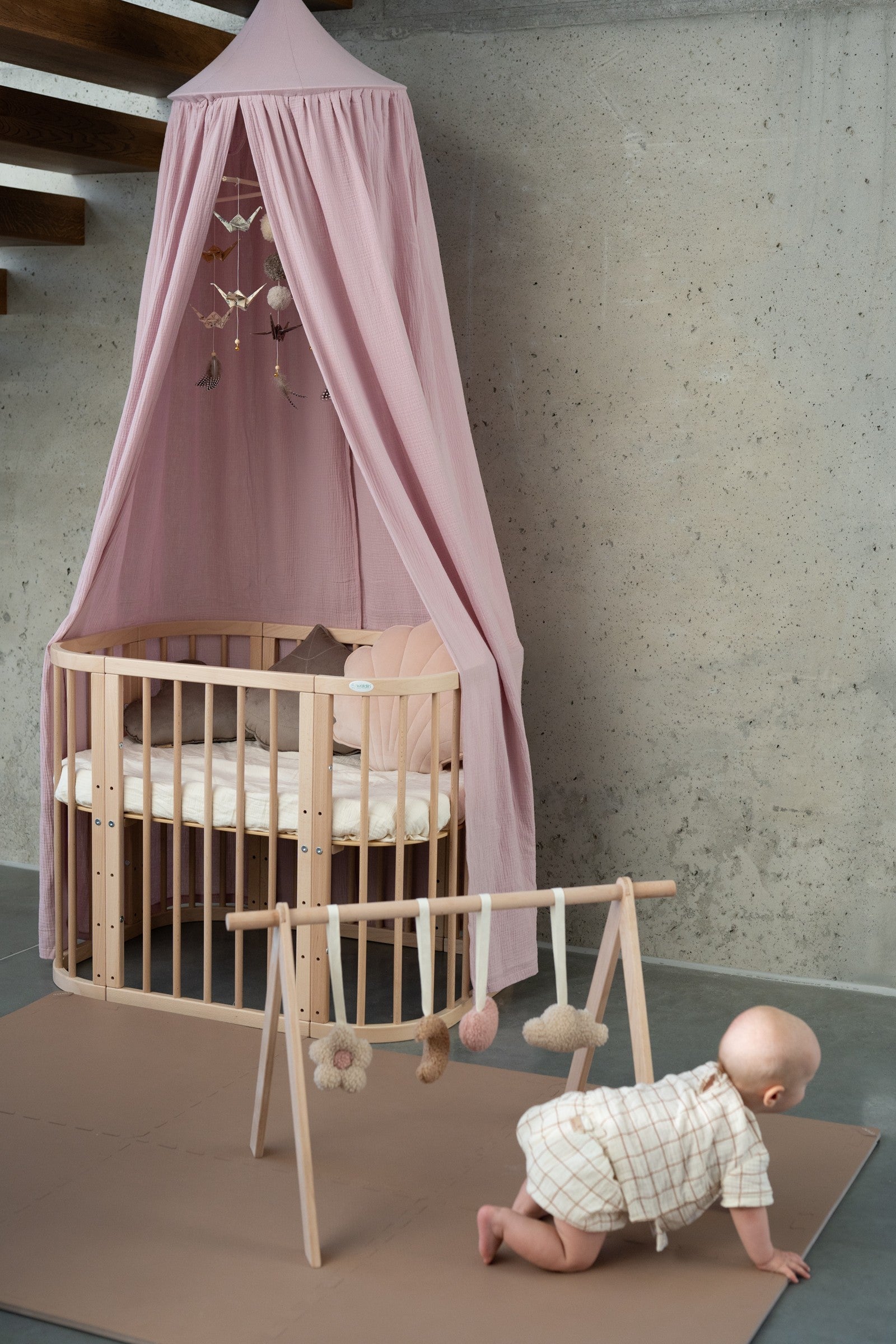 bold baby pink organic cotton canopy hanging over a bed, creating a confident and dreamy hideaway