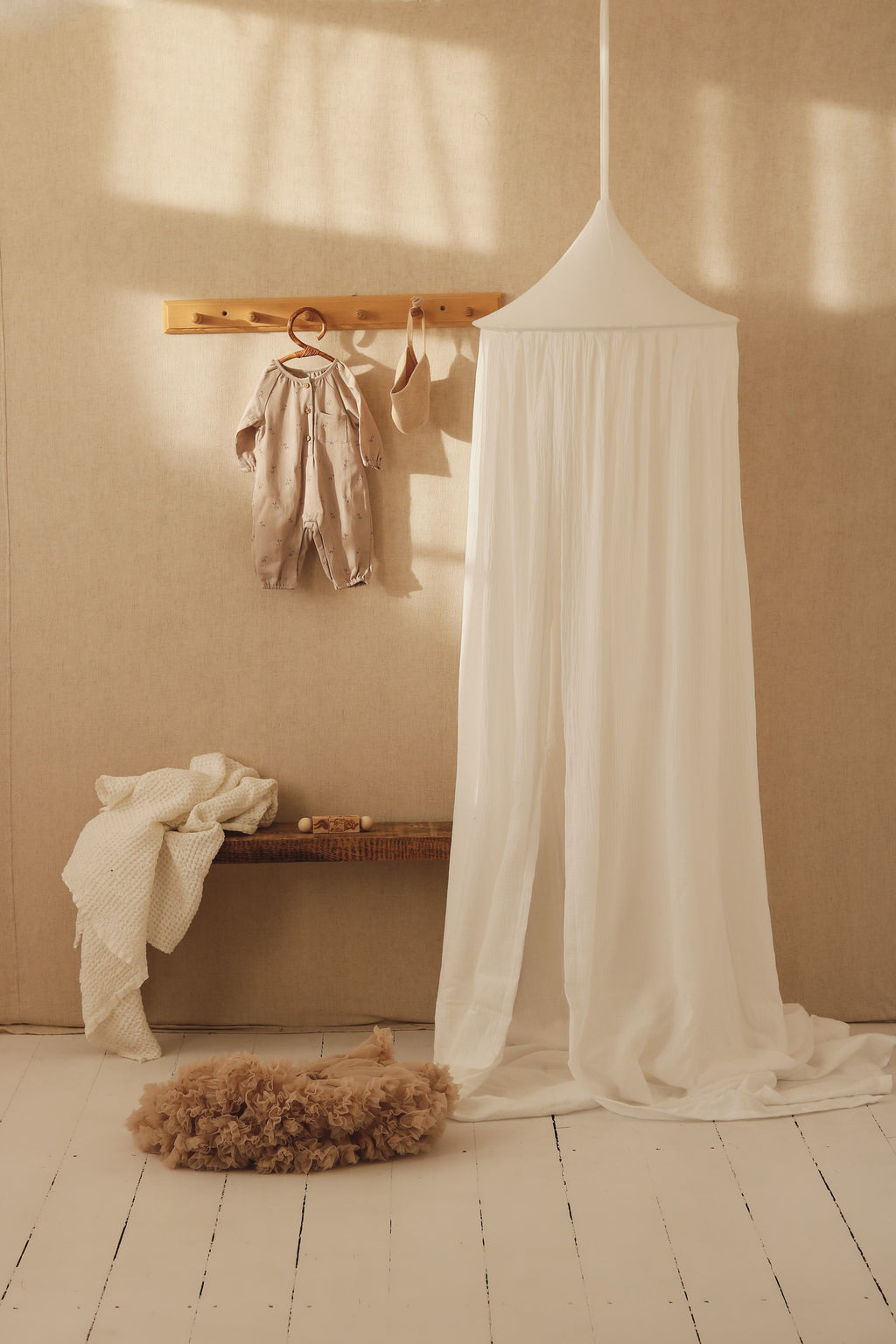 bold cream organic cotton canopy hanging over a cozy bed, ready for quiet play or dreamy naps