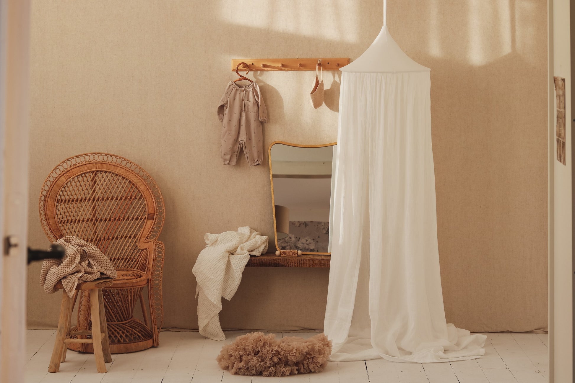 handmade cream cotton canopy hanging over a serene reading nook with soft morning light
