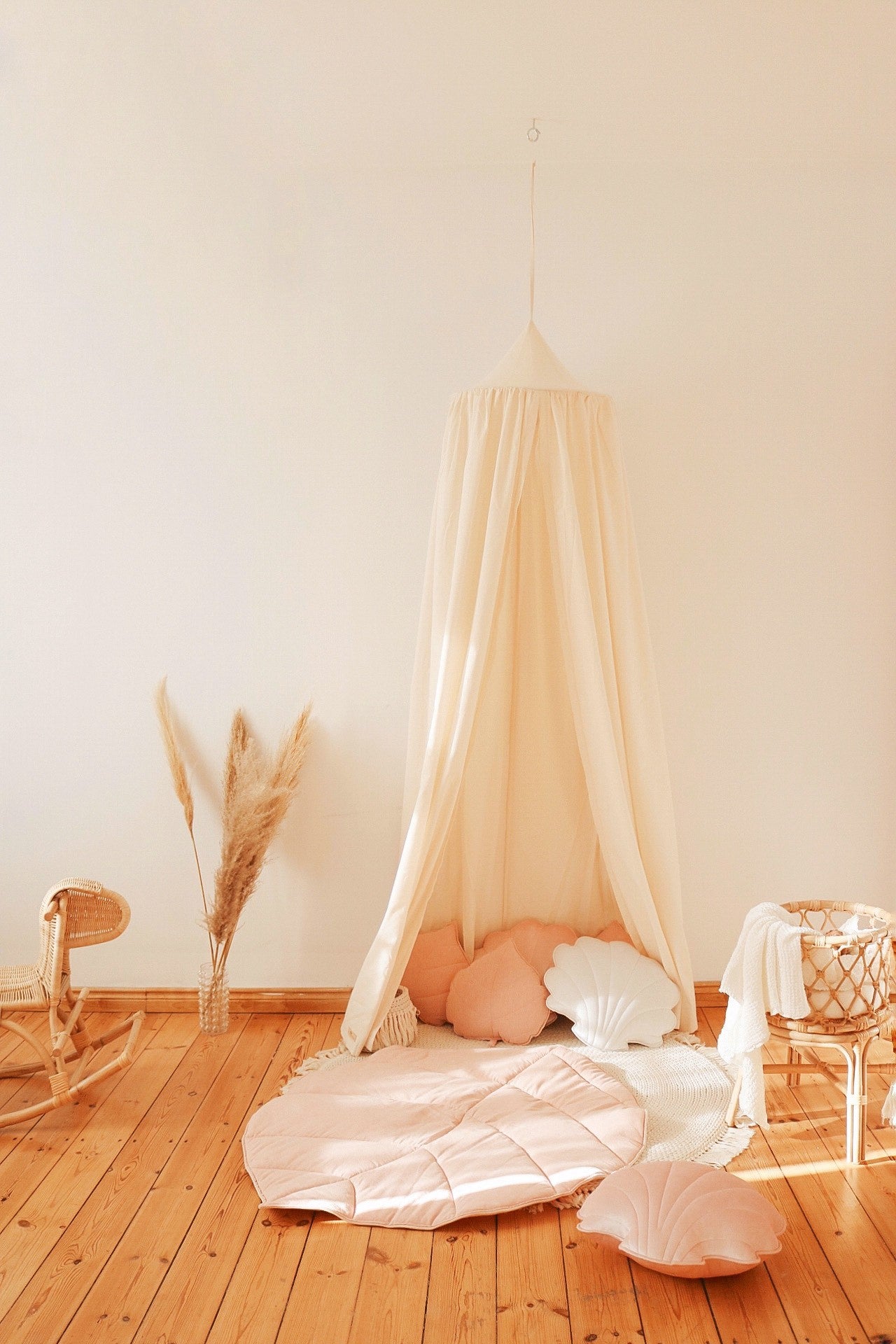 elegant raw cotton canopy draped gracefully over a bed, soft natural folds catching golden afternoon light