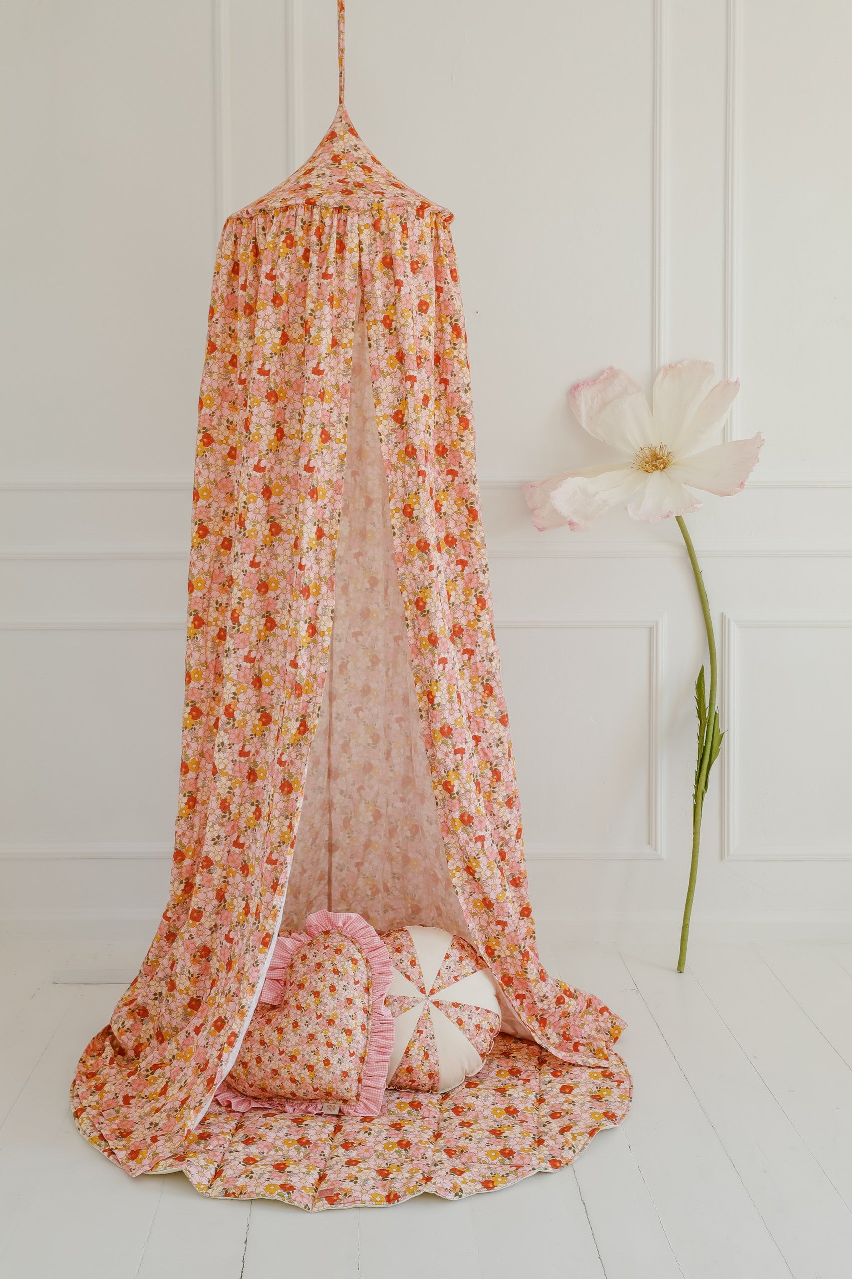 bold mint organic cotton canopy hanging over a cozy bed with soft sunlight streaming through