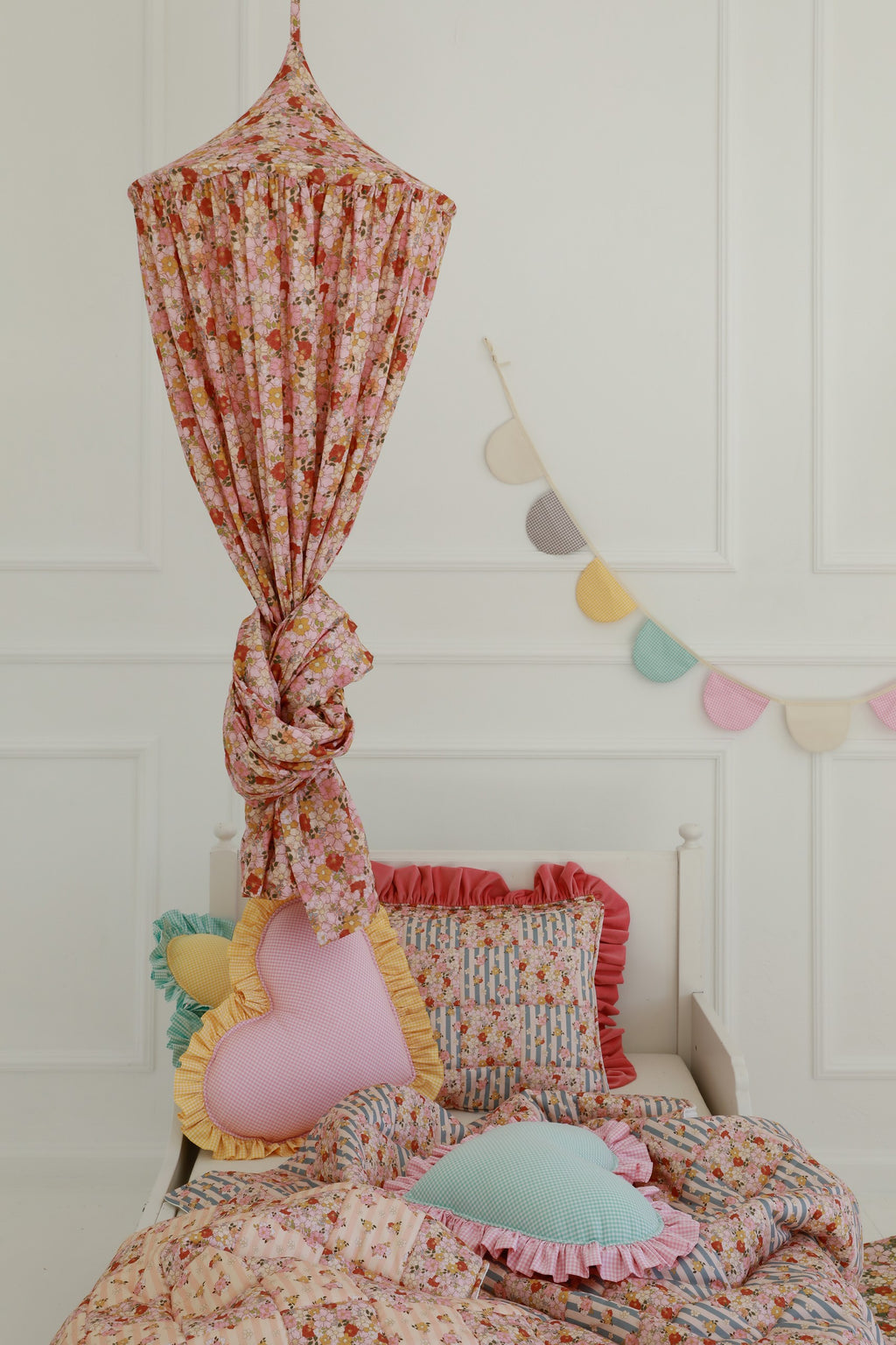 mint organic cotton canopy hanging over a cozy reading nook with soft sunlight filtering through