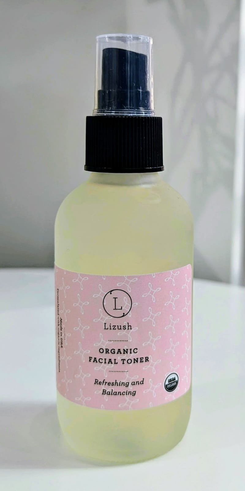 elegant glass bottle of organic lavender and bergamot facial toner on a marble surface