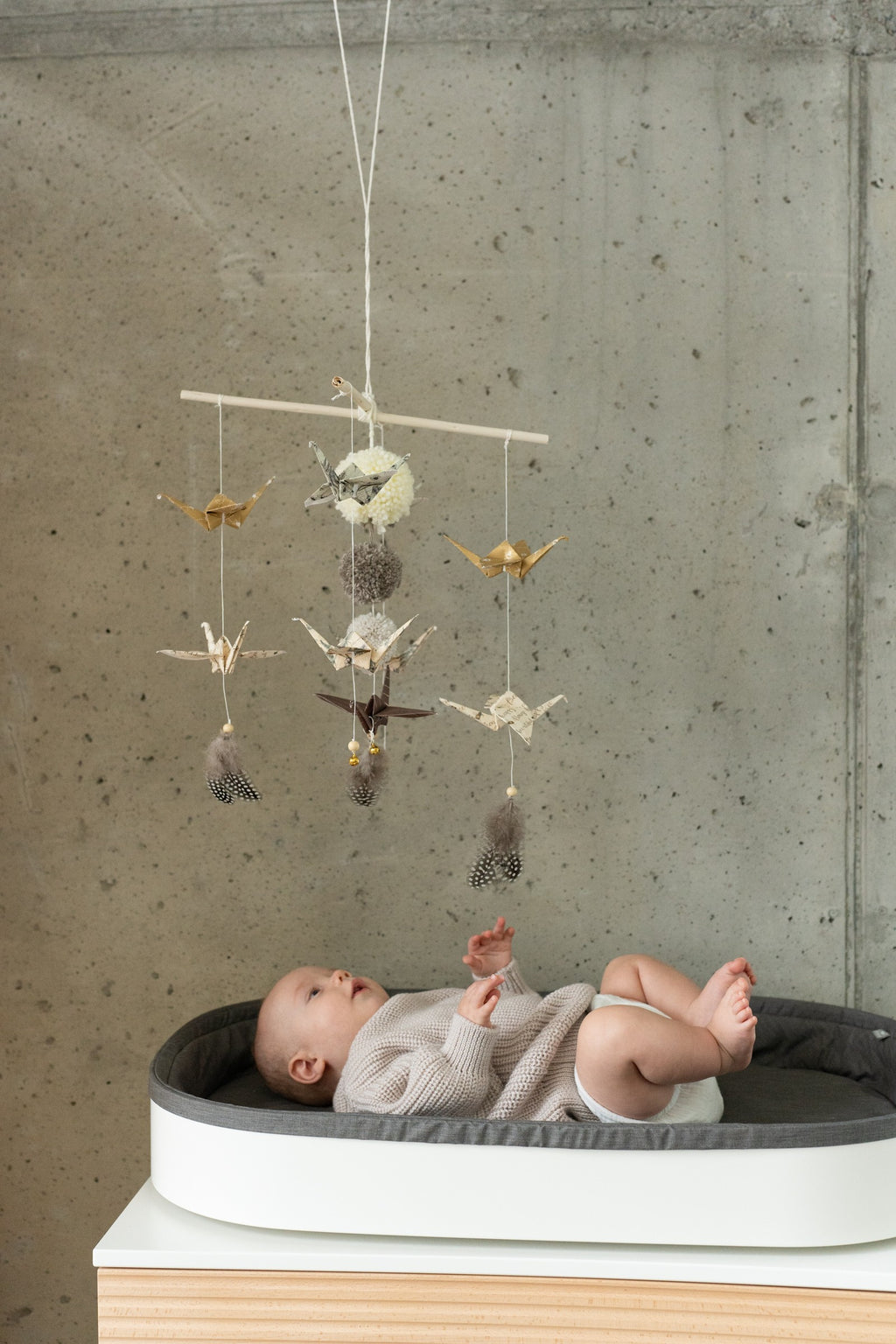 practical view of handmade origami mobile showing sturdy wooden stick and secure yarn attachment