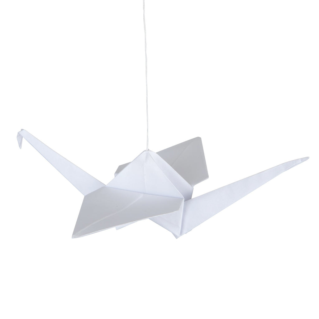 close-up of a playful handmade origami mobile with white cranes and soft pompoms dancing