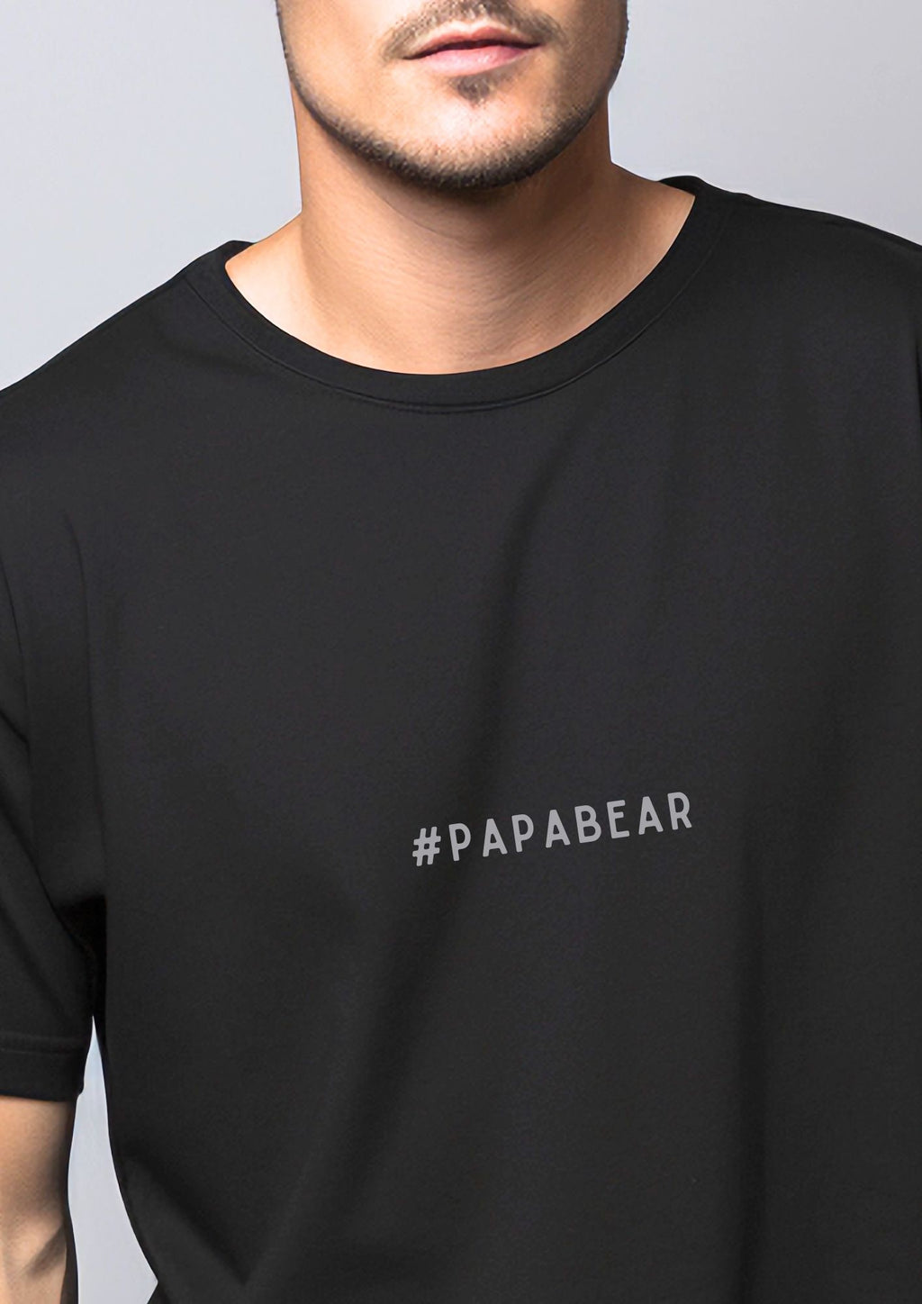 a bold close-up of the papabear t-shirt in a sunlit backyard setting