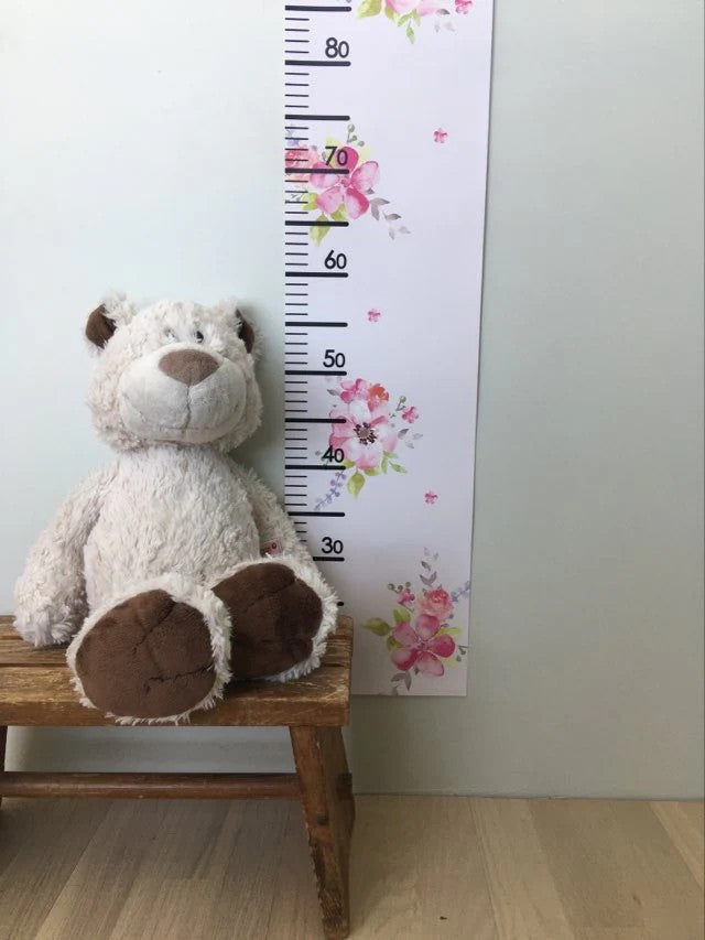 bold princess growth chart on a nursery wall with morning light