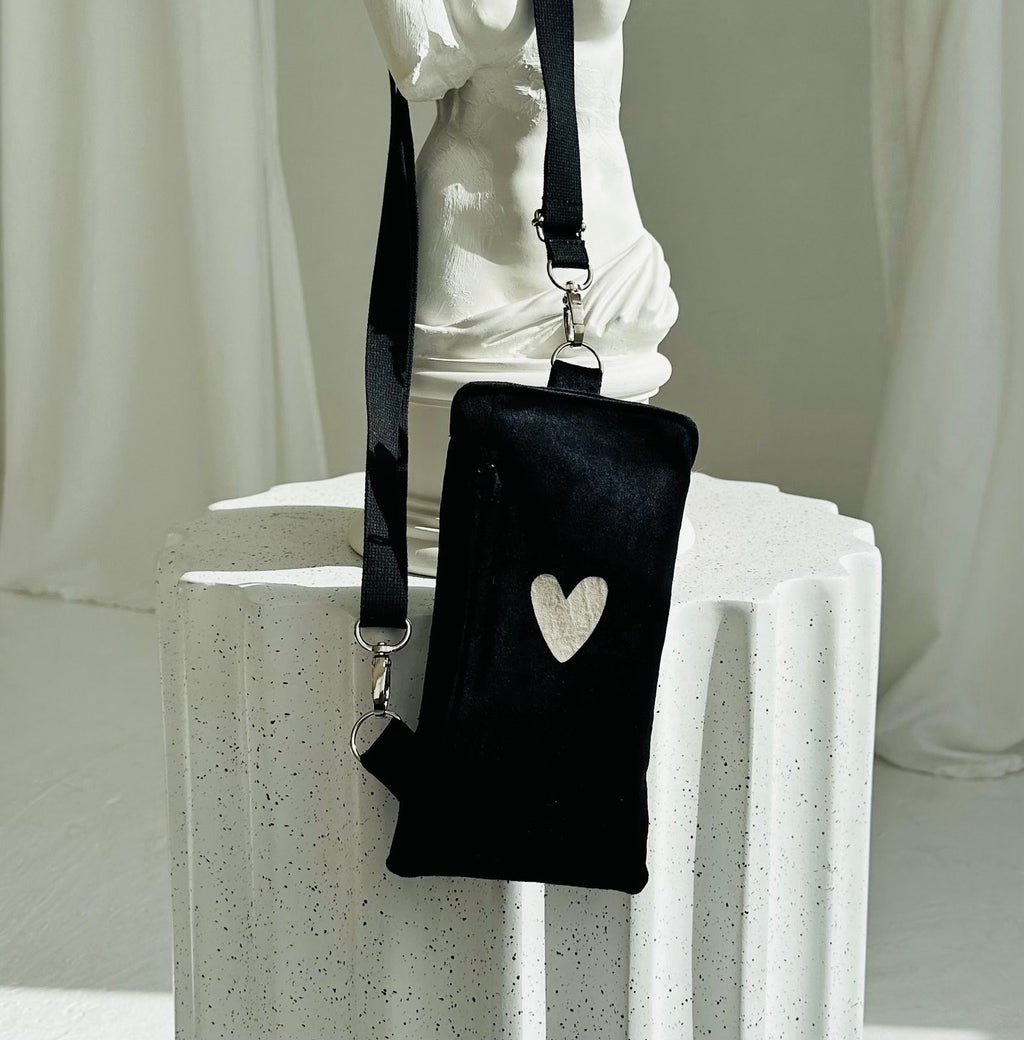 soft black velour heart phone bag with a cozy texture and adjustable strap for comfortable wear