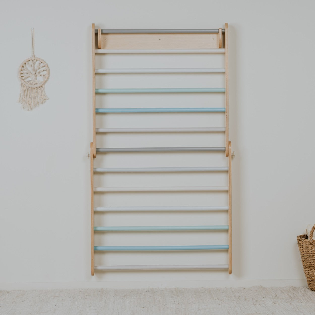 a child's hand reaching for a pastel climbing wall in soft morning light