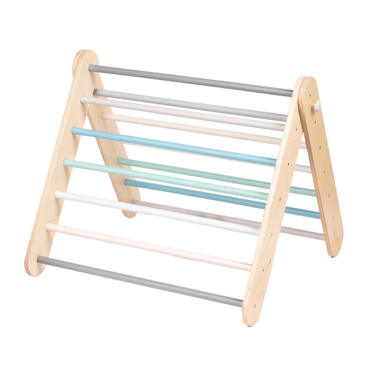 a child's hand reaching for the pastel climbing wall in soft morning light