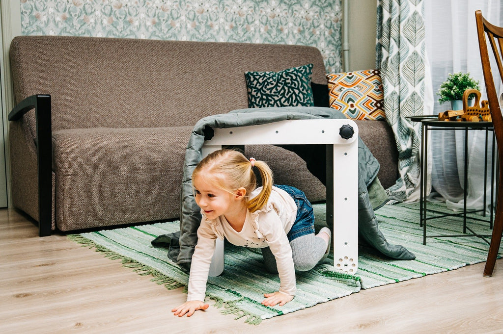 pikler triangle in a cozy nursery corner with soft morning light
