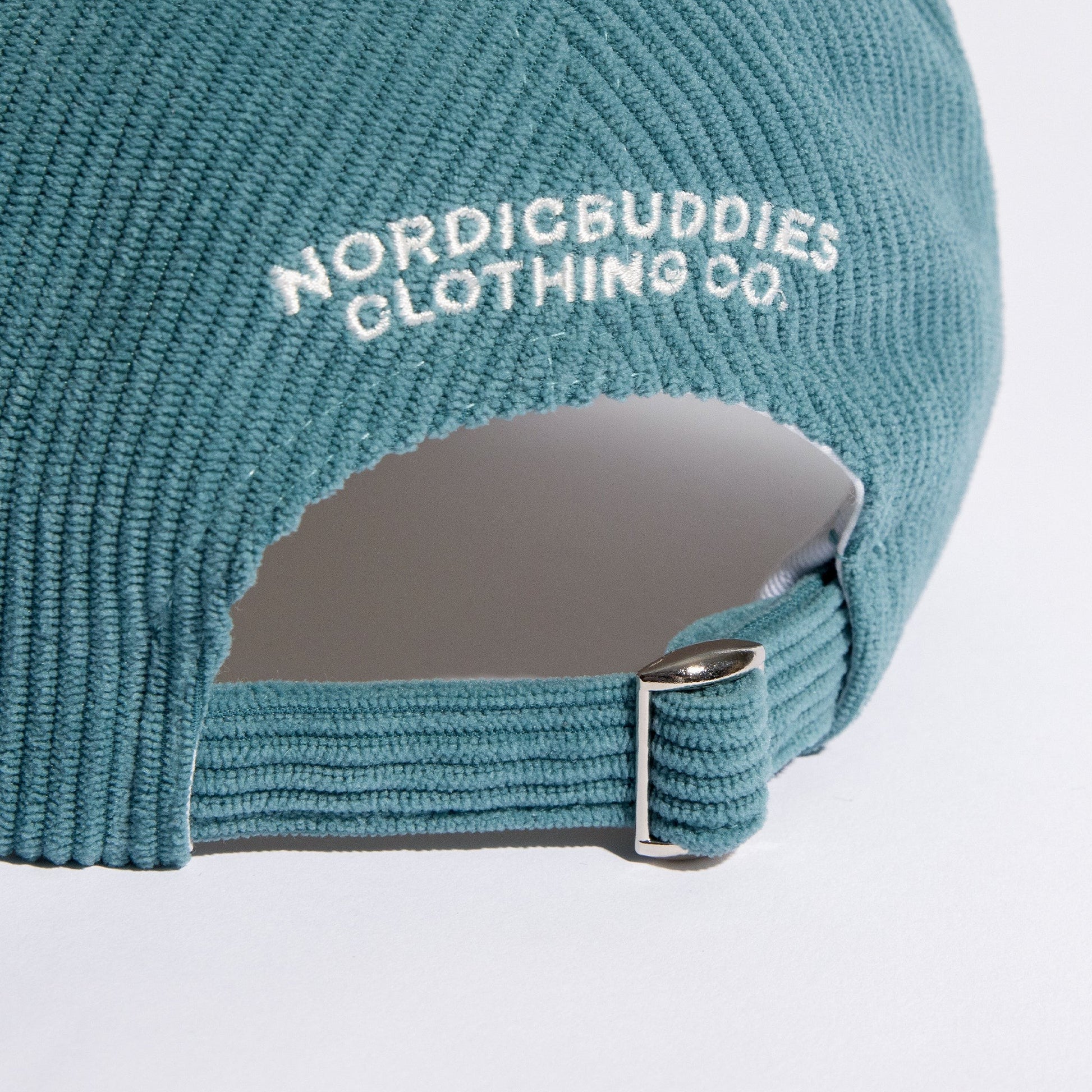 practical close-up of the petrol blue pippi cap's adjustable strap for a custom fit
