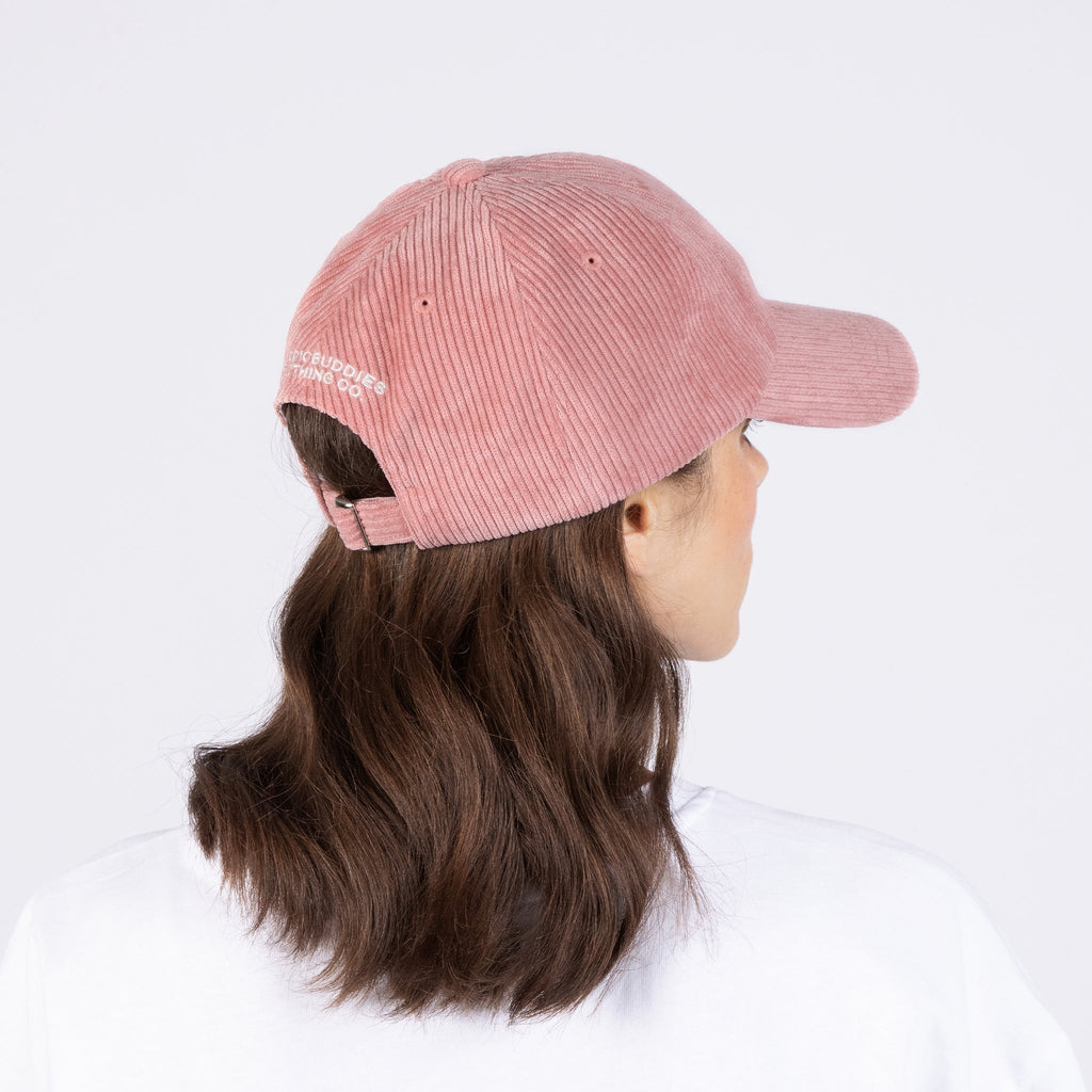 elegant pink corduroy dad cap on a minimalist background, showcasing its refined texture and adjustable strap