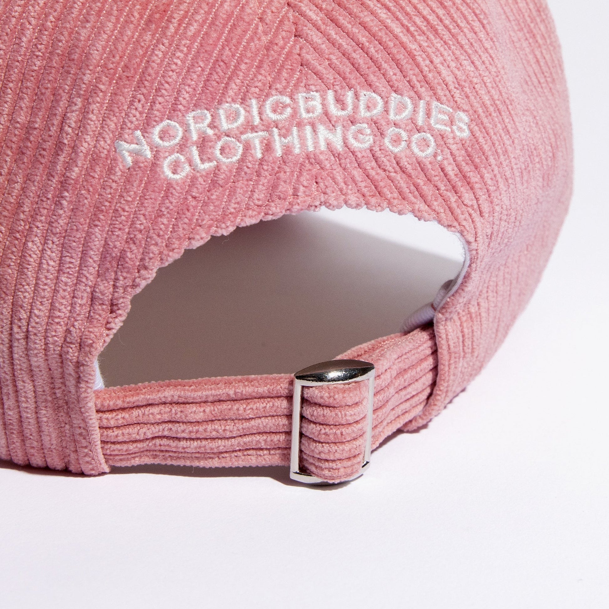 pink pippi corduroy dad cap from a practical side angle showing the adjustable strap and durable fabric