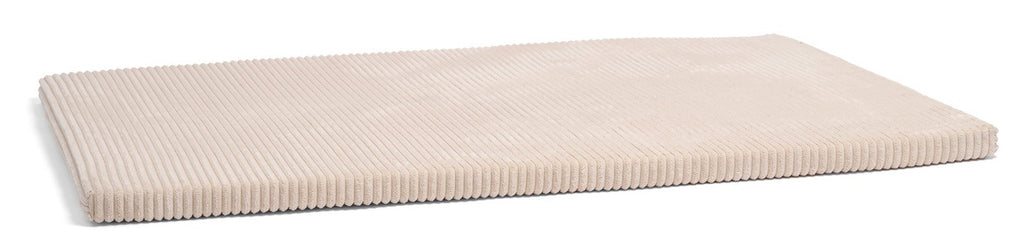 a child's hand gently tracing the soft recycled fabric of a mint green play mat